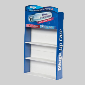 A blue and white Blistex display stand with three empty shelves. The top section showcases an image of the lip balm product labeled "Blistex Lip Infusion Sheer Liquid Balm," featuring the phrases "Discover What Your Lips Are Missing" and "Lip Care." The packaging highlights product visibility effectively.