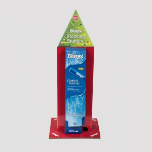 A Blistex display stand in the shape of a holiday stocking with festive holiday graphics. The packaging advertises Blistex Complete Moisture lip balm and features prominent branding. The display is red with Blistex and Walgreens logos.