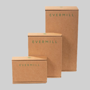 Three brown cardboard boxes of varying sizes labeled "EVERMILL" in green text are stacked against a gray background. The sharp graphics on the packaging create a striking visual, with the smallest package in the front and the largest at the back, forming a tiered arrangement.