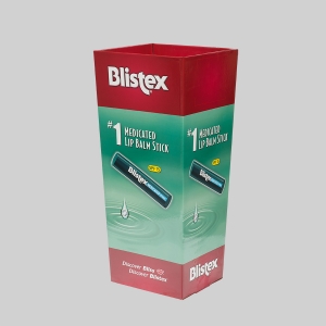 A promotional Blistex display stand featuring sharp graphics in a large red and green design. The packaging showcases an image of a Blistex Medicated Lip Balm Stick with SPF 15. The text reads, "#1 Medicated Lip Balm Stick" and "Discover Bliss. Discover Blistex.