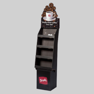 A black cardboard display stand with four shelves is shown, featuring sharp graphics with a coffee cup and the text "Simply Great Coffee Since 1900." The brand name "Boyds" is displayed at the bottom of the stand. The background is gray, enhancing the eye-catching packaging.