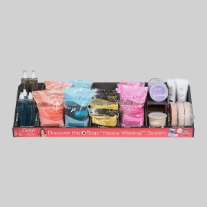 A display tray holds various waxing products, including bottles of wax cleaner, different colored bags of wax beads, wax cartridges, pre- and post-wax treatments, and waxing strips. The attractive packaging is eye-catching. A red banner at the front reads, "Discover the 3 Step 'Happy Waxing' System.