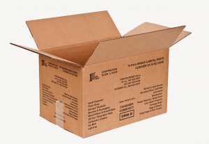 A brown cardboard shipping container with flaps partially open displays various texts and logos on the sides, including shipping information and product details such as "Hand Cleaners," "Floor Soaps," and "Cleaner 24-oz cans." The packaging is from 1st Ayd Corporation.