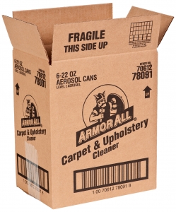 A brown cardboard shipping container labeled "Armor All Carpet & Upholstery Cleaner" features sharp graphics with a knight's helmet logo. The box is open, marked "Fragile" and "This Side Up," and contains 6-22 oz aerosol cans. Stock number and barcodes are also visible.