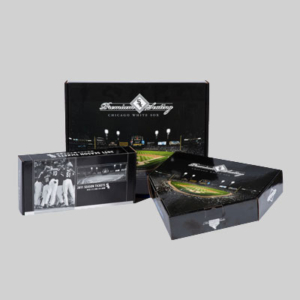 Three black boxes with the Chicago White Sox branding on a gray background. The packaging features sharp graphics displaying images of a baseball stadium and players. One box reads "2011 Season Tickets" and shows a scene of players in the dugout, reminiscent of an exclusive subscription box.