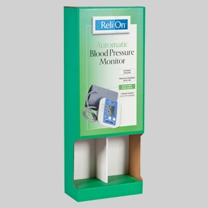 A green and white cardboard display stand for the ReliOn Automatic Blood Pressure Monitor, featuring sharp graphics of the device and its cuff, along with descriptions of its features. The stand includes an empty shelf space at the bottom, making it perfect for holding additional packages or serving as a shipping container.