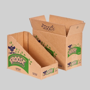 Two brown cardboard boxes are displayed against a plain background. One box, resembling a stylish shipping container, is designed to be a magazine holder with a slanted opening and the word “FROOSE” alongside a playful character. The other box remains intact with similar branding.