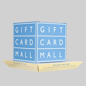 A blue and white cardboard box with the words "GIFT CARD MALL" printed repeatedly on each of its sides. The box is open at the top, revealing more packages inside. A yellow flap at the bottom has small printed text in sharp graphics. The background is gray.