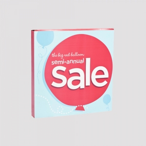 A square sign features a sharp graphic of a red balloon, with white text reading "the big red balloon semi-annual Sale." The light blue background is adorned with smaller balloon illustrations.