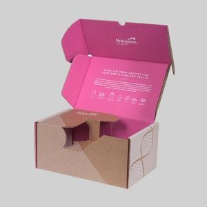 A partially opened cardboard box with a pink interior and white exterior. The inside lid has text and icons promoting baby's feeding health, along with the brand name "Nutrimom." This subscription box also features sharp graphics and a geometric design on the outside.