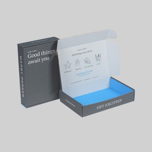 A black and blue cardboard box is shown with "Warby Parker" printed on the side. The lid is open, revealing a white interior adorned with sharp graphics and text. The outer package reads "Good things await you," and the inner flap says "Good things come in fives...Get excited!