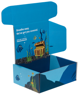 Open blue cardboard box with sharp graphics; the inside lid features an underwater scene with fish, seaweed, rocks, bubbles, and a treasure chest. Text on the lid reads, "Breathe easy. We've got you covered. GOLUB CAPITAL." The outer sides of the package show underwater graphics.