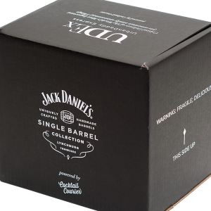 A black cardboard box featuring the Jack Daniel's Single Barrel Collection logo and text, indicating it contains handcrafted barrels from Lynchburg, Tennessee. The package has sharp graphics with a "This Side Up" arrow and a warning label that reads "FRAGILE: DELICIOUSNESS INSIDE.