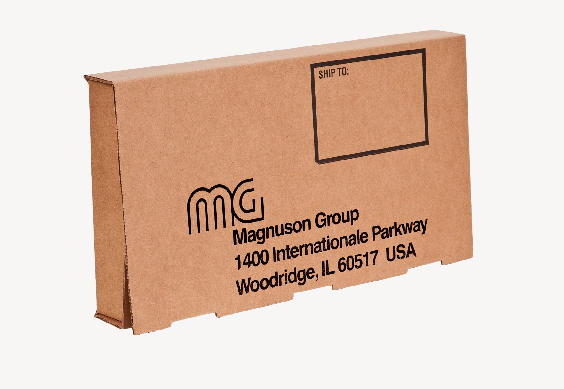 A brown cardboard shipping box with black text that reads "Magnuson Group, 1400 Internationale Parkway, Woodridge, IL 60517 USA." The package has a blank "Ship To:" section in the upper right corner.