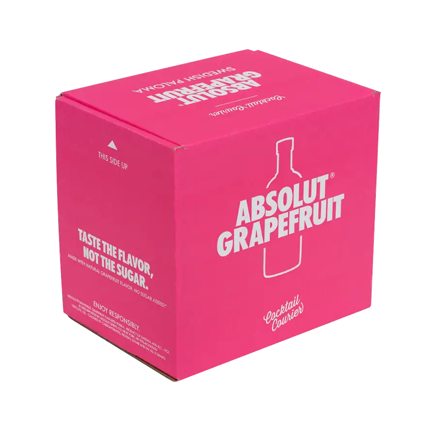 A pink package with white text displaying the Absolut Grapefruit logo. The phrase "TASTE THE FLAVOR, NOT THE SUGAR" is prominent on one side. There is a white outline of a bottle and the phrases "Cocktail Carrier" and "ENJOY RESPONSIBLY" also appear on the shipping box, enhanced by eye-catching graphics.