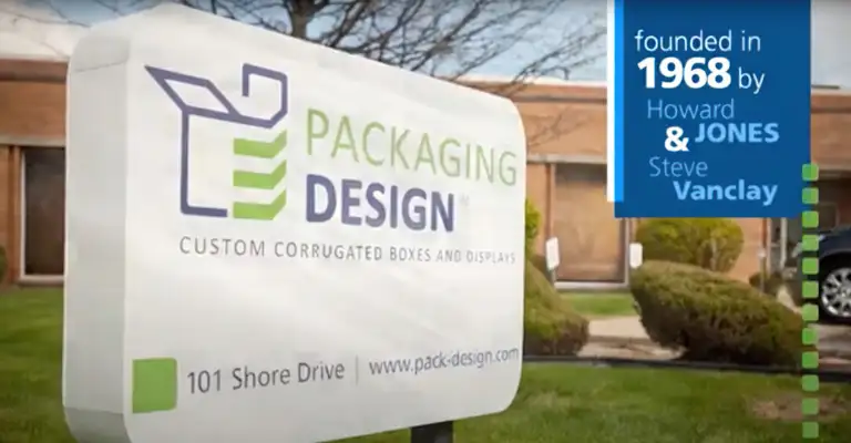 A photo shows the sign for Packaging Design, a company specializing in custom corrugated boxes and displays with sharp graphics, featuring a logo and an address at 101 Shore Drive. A blue overlay states the company was founded in 1968 by Howard Jones and Steve Vanclay.